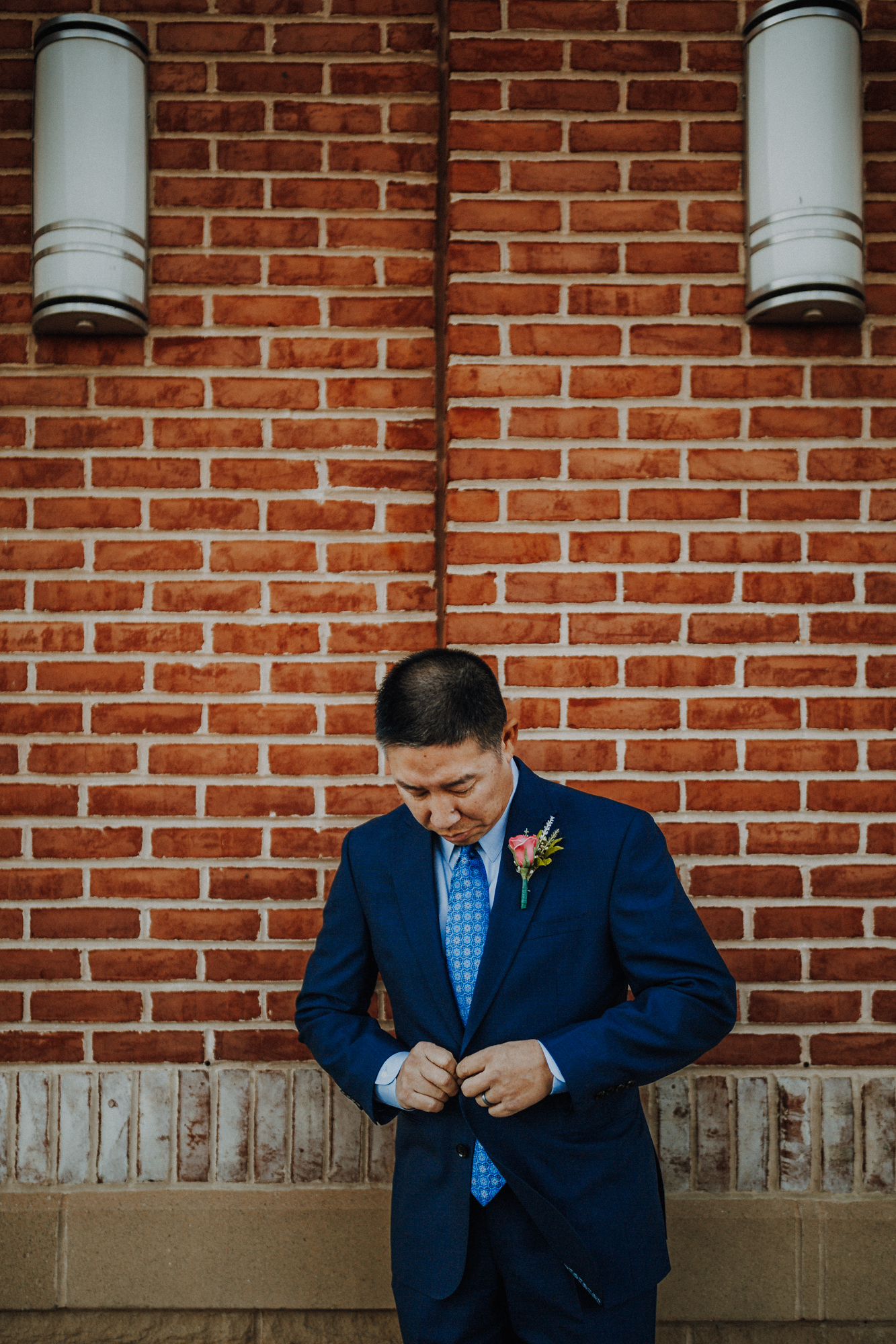Groom checking jacket buttons
